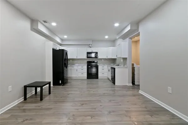 a kitchen with stainless steel appliances a refrigerator and a stove top oven