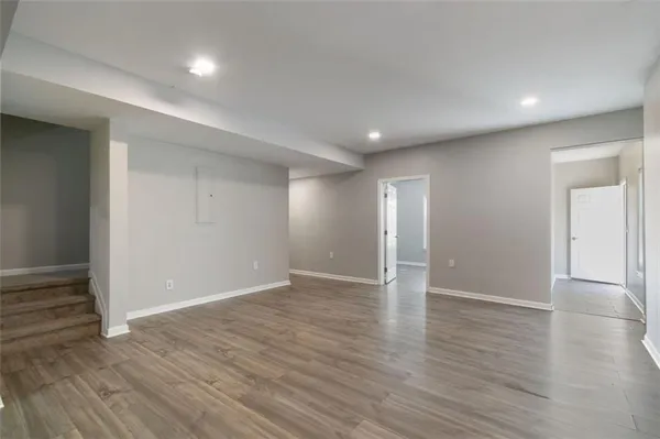 a view of an empty room with wooden floor