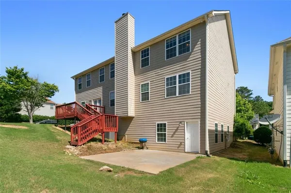 a view of a house with a yard and wooden fence