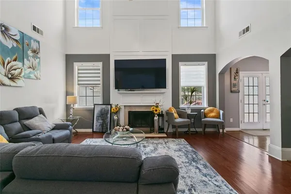a living room with furniture a fireplace and a flat screen tv