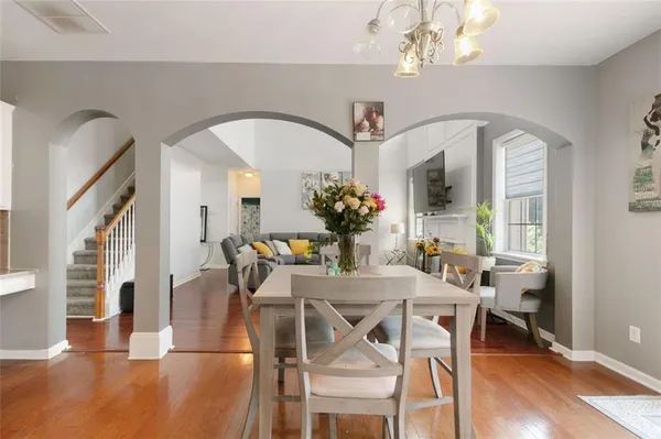 a view of a dining room with furniture wooden floor and chandelier