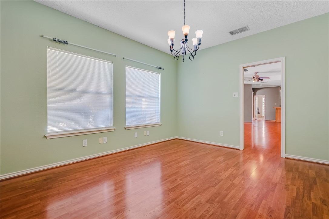 5917 Harvest Hill Road Corpus Christi, TX 78414 - Photo 12 of 40 a view of an empty room with wooden floor and a window
