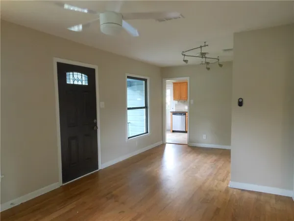 a kitchen with granite countertop a stove sink and cabinets