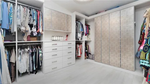 an aerial view of residential houses with outdoor space and ocean view