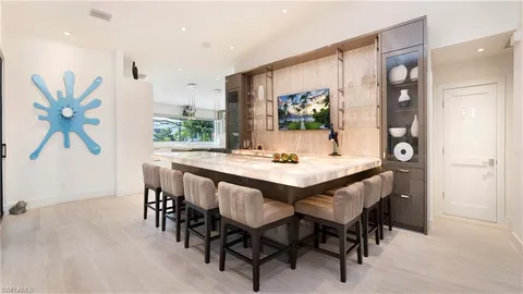 a kitchen with a sink a counter space appliances and cabinets