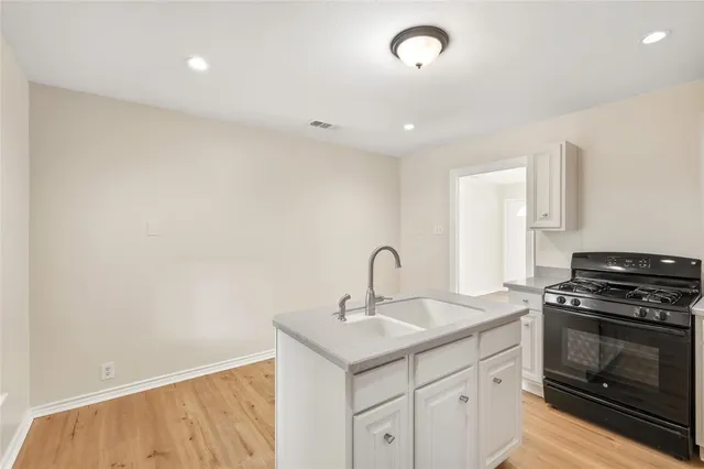 a kitchen with a sink cabinets and appliances