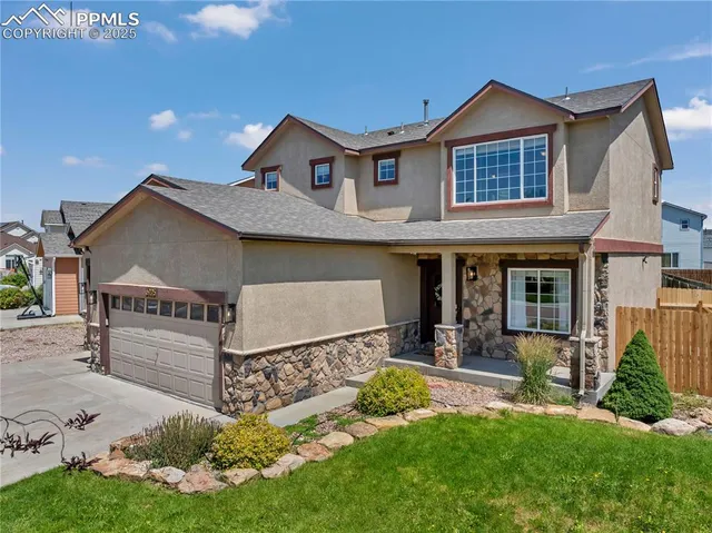 a front view of a house with a yard table and chairs