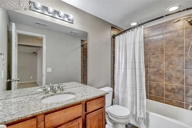 an empty room with windows and fireplace