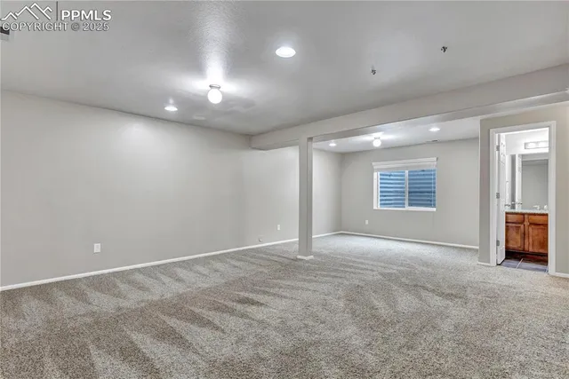 a view of a livingroom with a ceiling fan and window