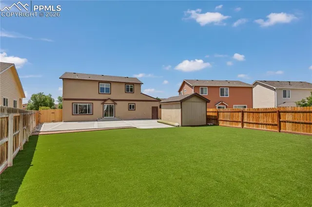 an aerial view of a house with a mountain