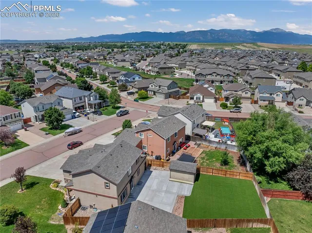 an aerial view of residential houses with outdoor space and river