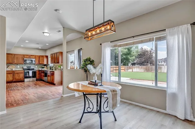 a view of a dining room with furniture window and outside view