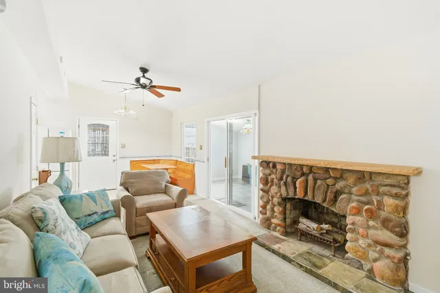 a kitchen with a sink a refrigerator a stove a washer dryer and a dining table with wooden floor