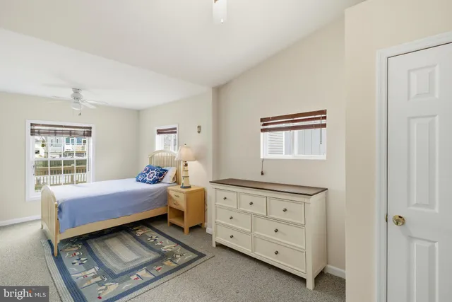 a bedroom with a bed and a tv on the dresser