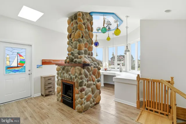 a room with a large window and a table chair