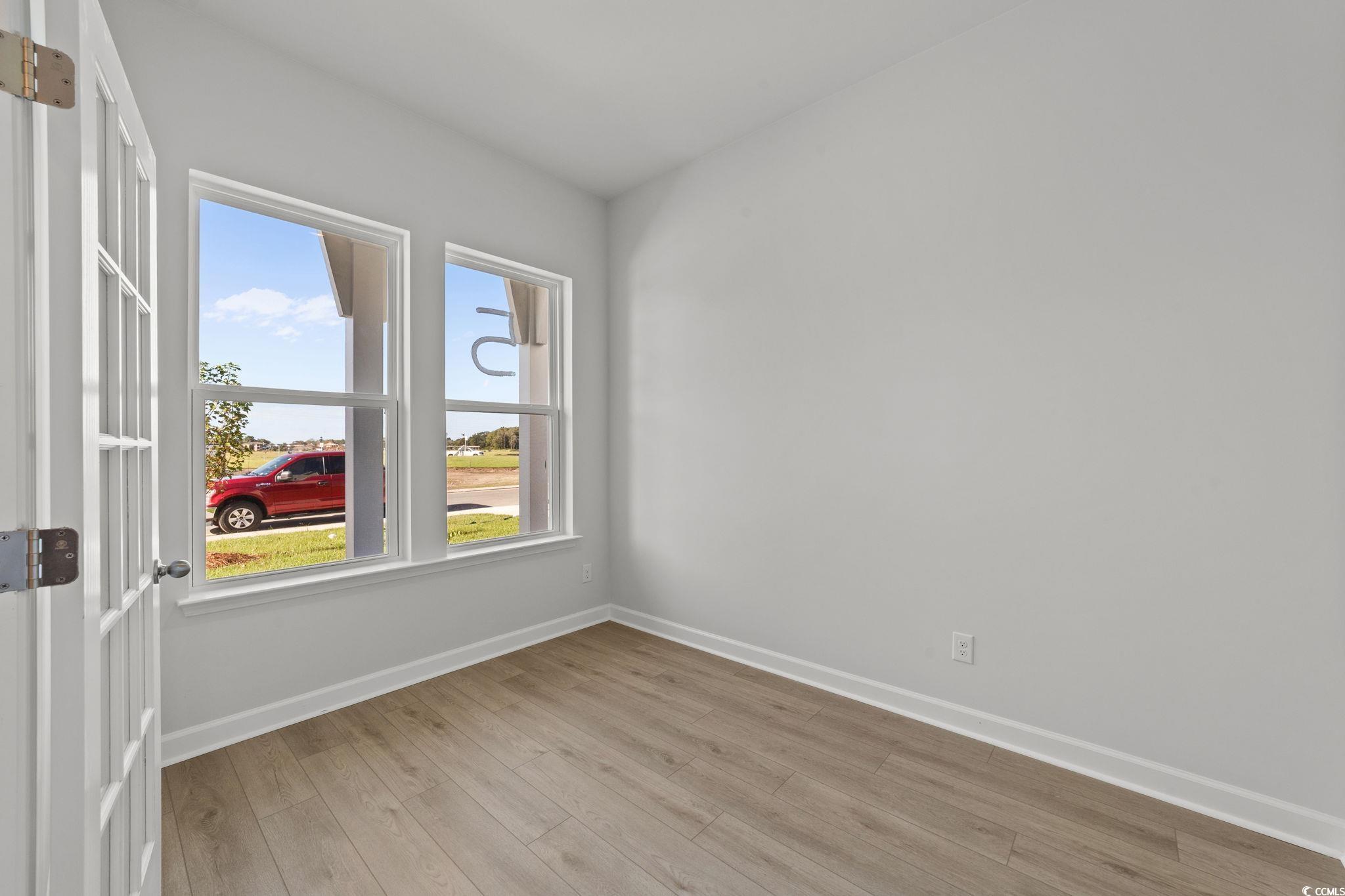 771 Ebb Tide Road Little River, SC 29566 - Photo 14 of 35 Empty room featuring baseboards and light wood-style floors