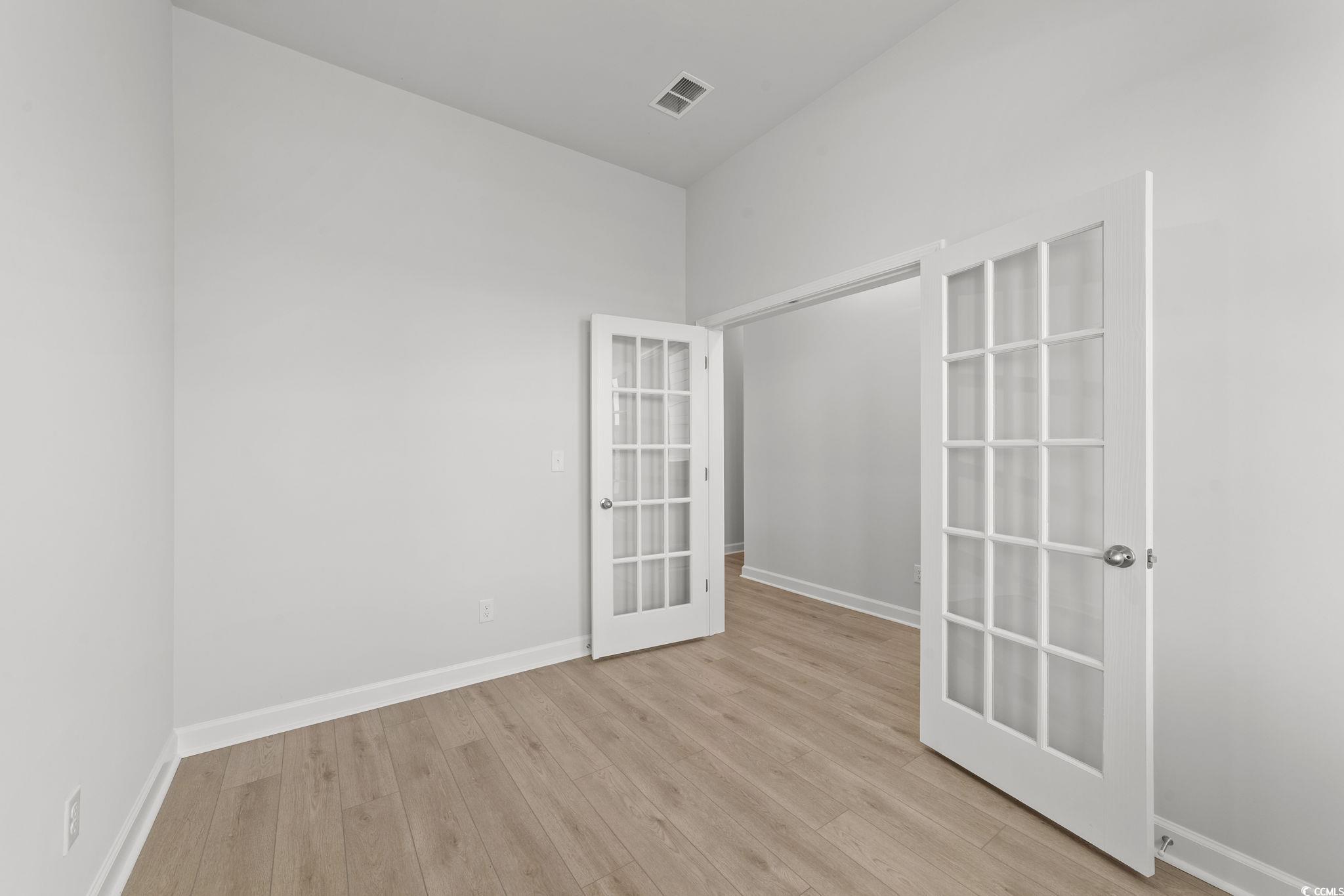 771 Ebb Tide Road Little River, SC 29566 - Photo 15 of 35 Spare room featuring light wood finished floors and french doors