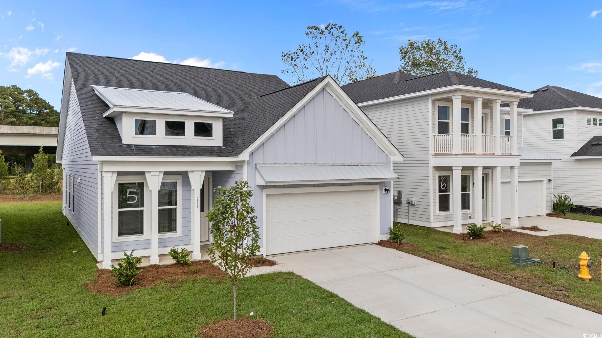 771 Ebb Tide Road Little River, SC 29566 - Photo 2 of 35 View of front facade featuring concrete driveway, a shingled roof, a garage, and a front yard