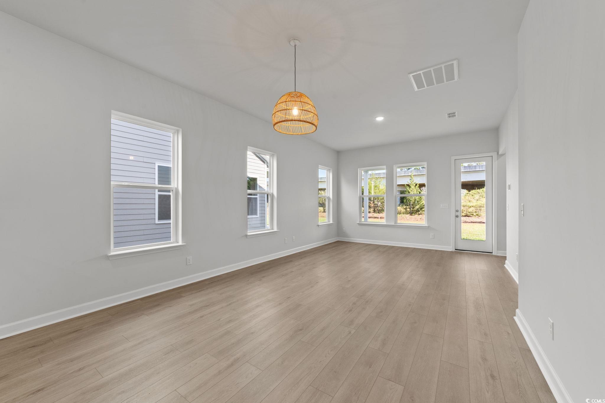 771 Ebb Tide Road Little River, SC 29566 - Photo 21 of 35 Spare room with light wood-style flooring, healthy amount of natural light, and recessed lighting