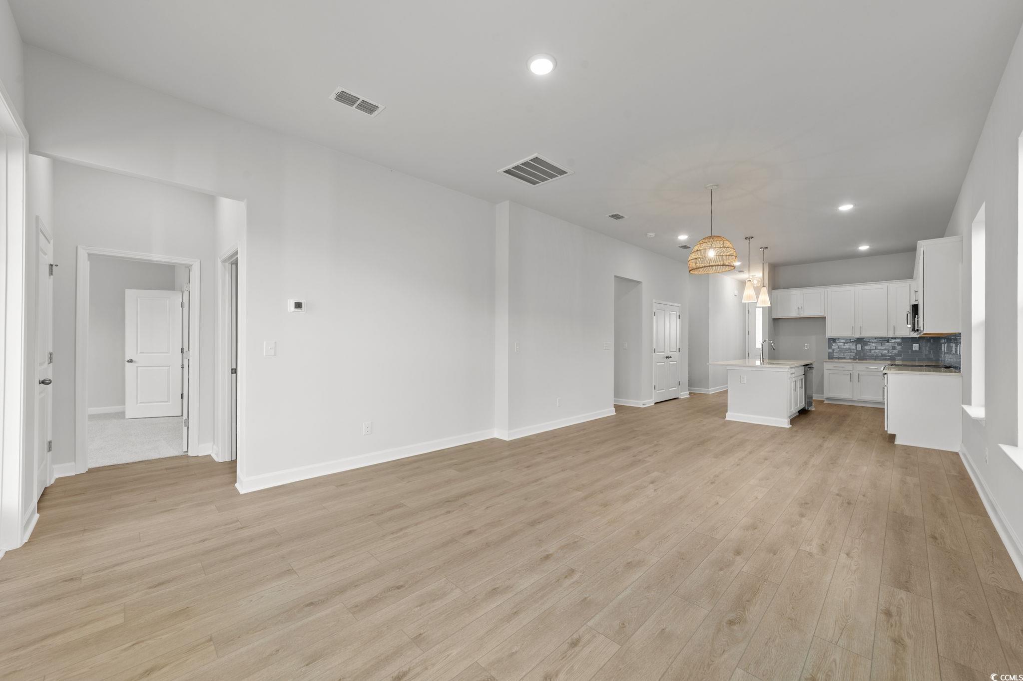 771 Ebb Tide Road Little River, SC 29566 - Photo 23 of 35 Unfurnished living room featuring light wood-type flooring and recessed lighting