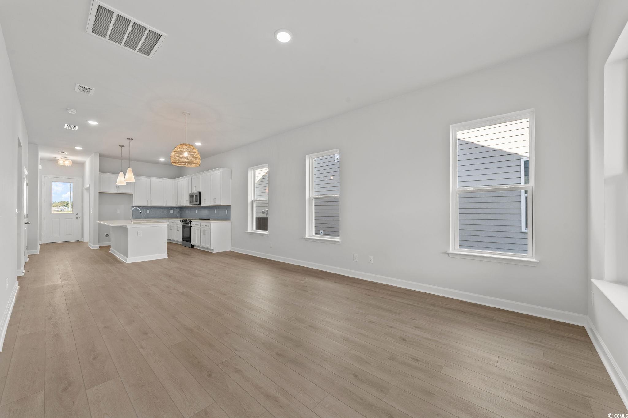 771 Ebb Tide Road Little River, SC 29566 - Photo 24 of 35 Unfurnished living room featuring recessed lighting and light wood-style floors