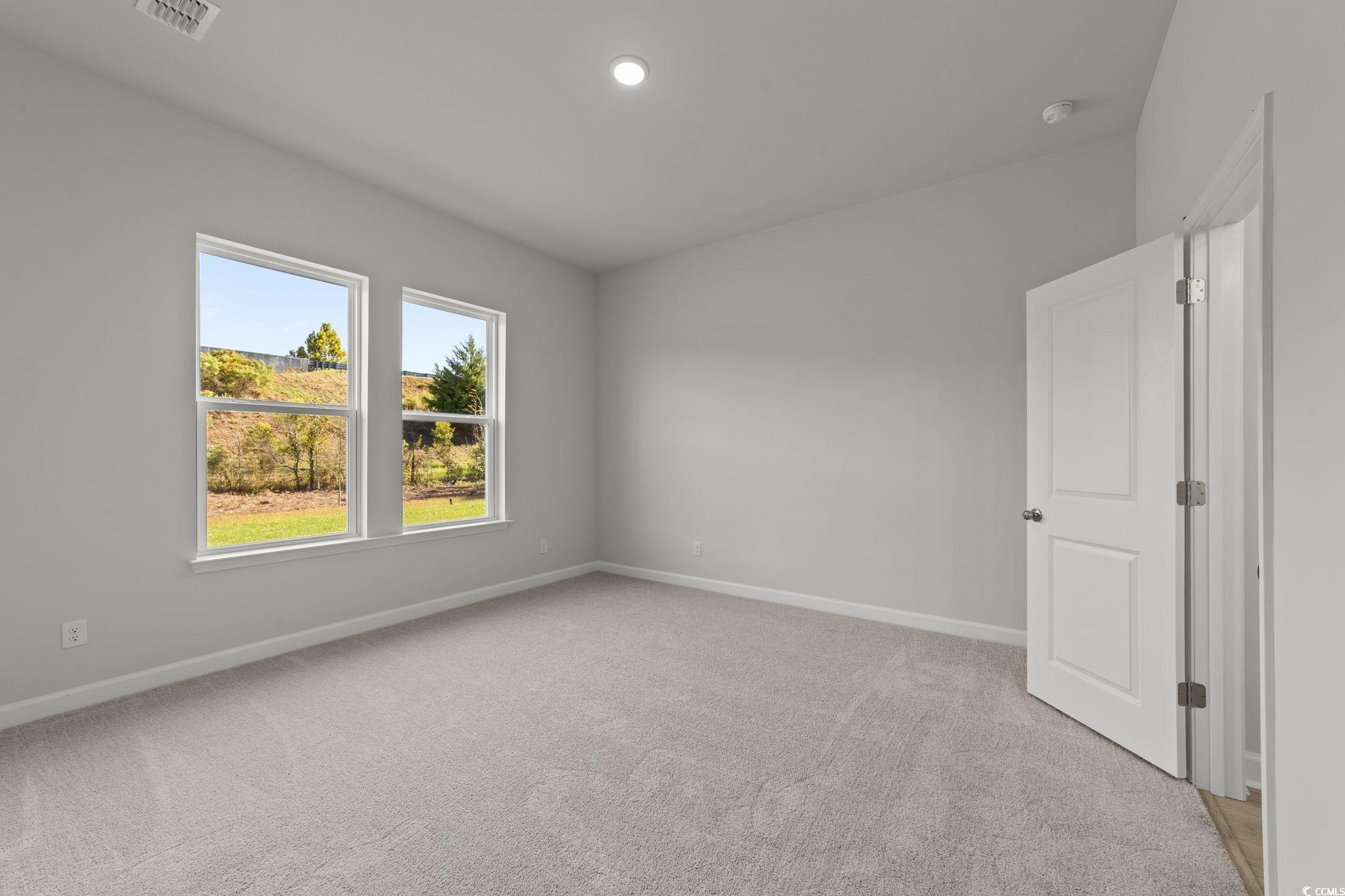 771 Ebb Tide Road Little River, SC 29566 - Photo 26 of 35 Empty room featuring light colored carpet