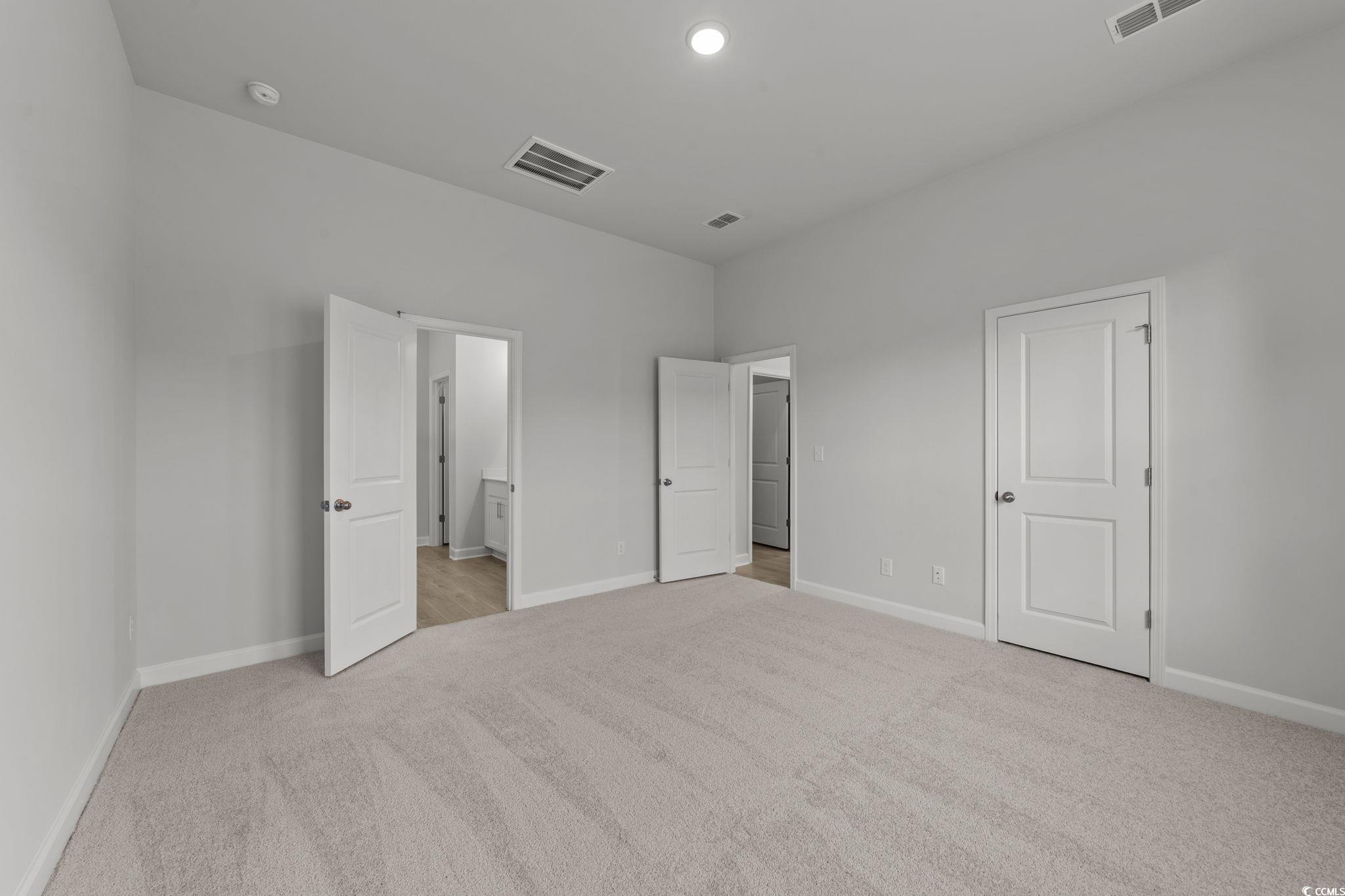 771 Ebb Tide Road Little River, SC 29566 - Photo 27 of 35 Unfurnished bedroom featuring light colored carpet, connected bathroom, and recessed lighting