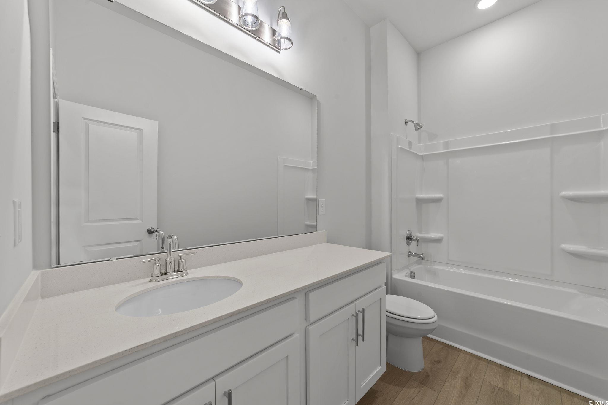 771 Ebb Tide Road Little River, SC 29566 - Photo 30 of 35 Full bath featuring vanity, shower combination, and light wood-style floors