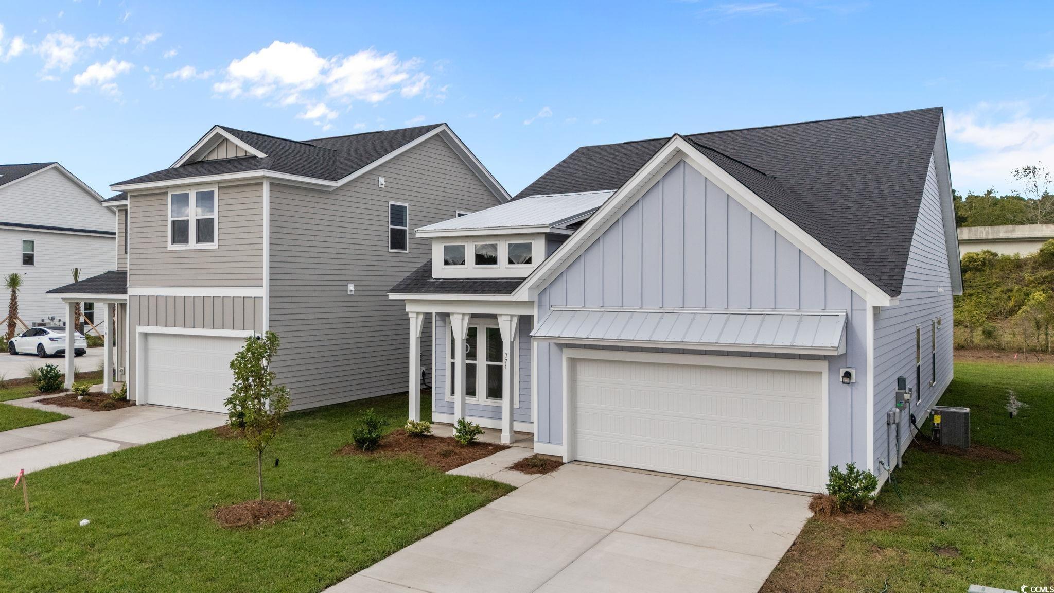 771 Ebb Tide Road Little River, SC 29566 - Photo 3 of 35 View of front facade with a shingled roof, a garage, and a front yard