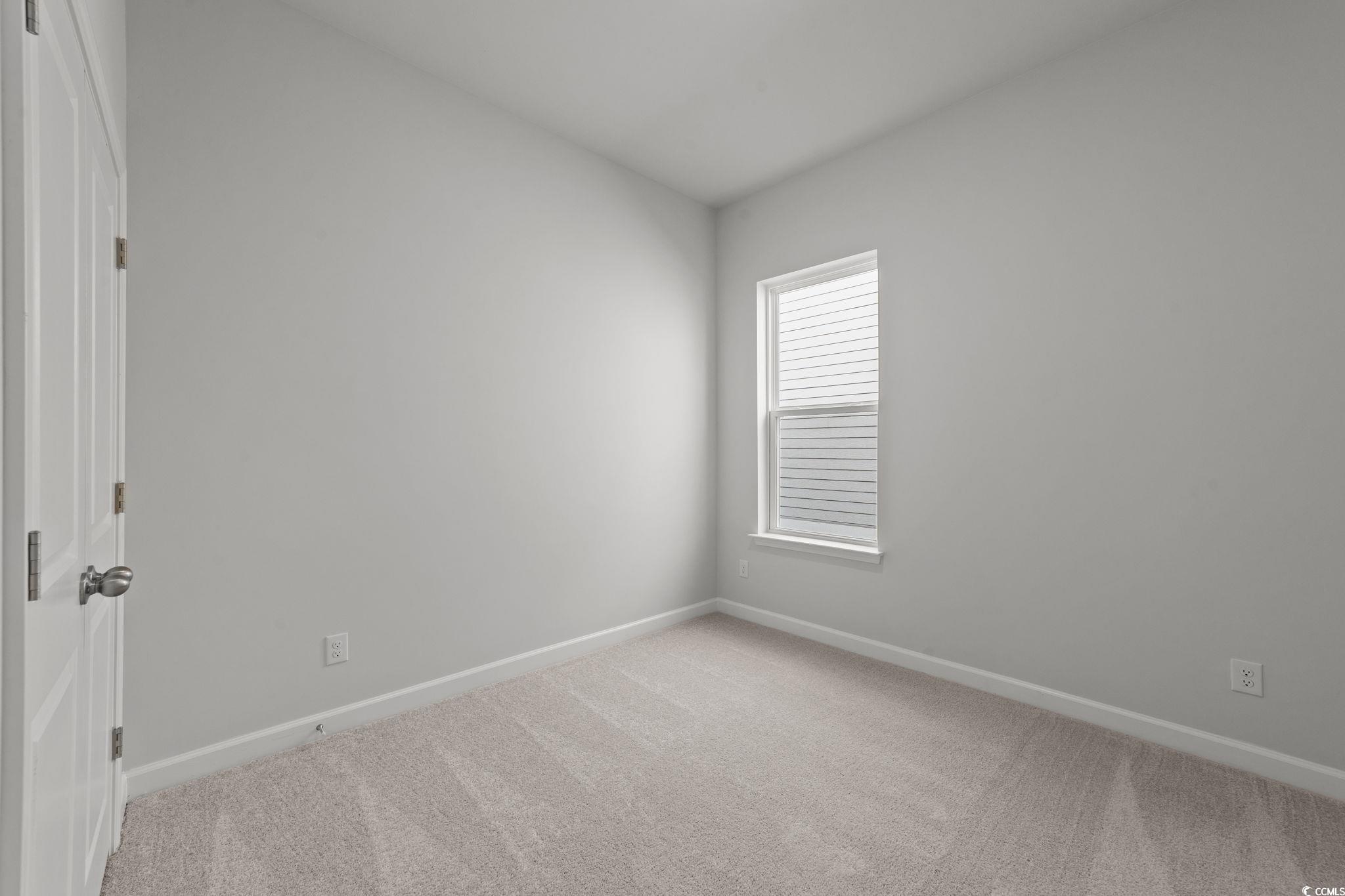 771 Ebb Tide Road Little River, SC 29566 - Photo 31 of 35 Empty room featuring baseboards and light colored carpet