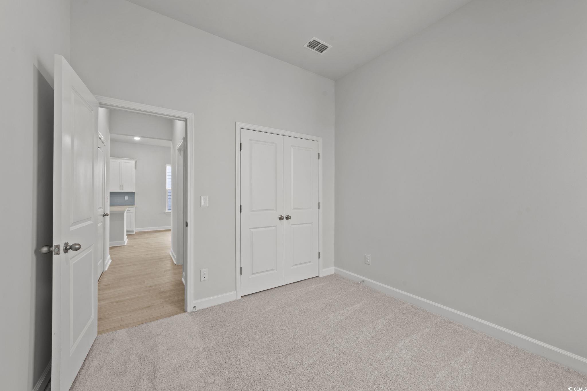 771 Ebb Tide Road Little River, SC 29566 - Photo 32 of 35 Unfurnished bedroom featuring light colored carpet and a closet