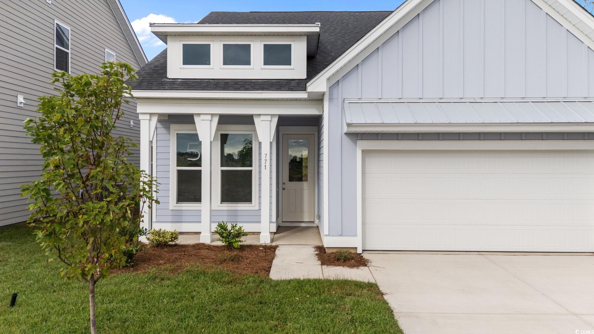 771 Ebb Tide Road Little River, SC 29566 - Photo 8 of 35 View of front facade featuring roof with shingles, board and batten siding, concrete driveway, and an attached garage