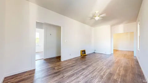 a view of a hallway with wooden floor