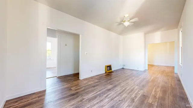 a view of a hallway with wooden floor