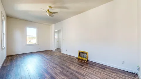 a kitchen with granite countertop a refrigerator and a sink