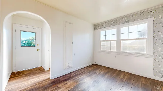 a view of a room with wooden floor and windows