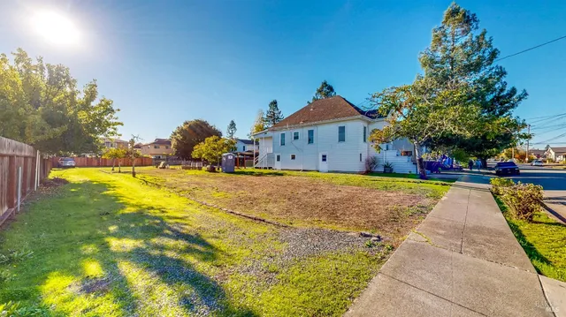 a front view of house with yard and trees