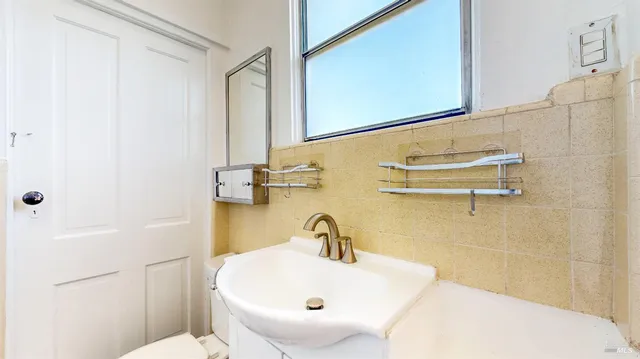 a view of a swimming pool with a patio and a yard