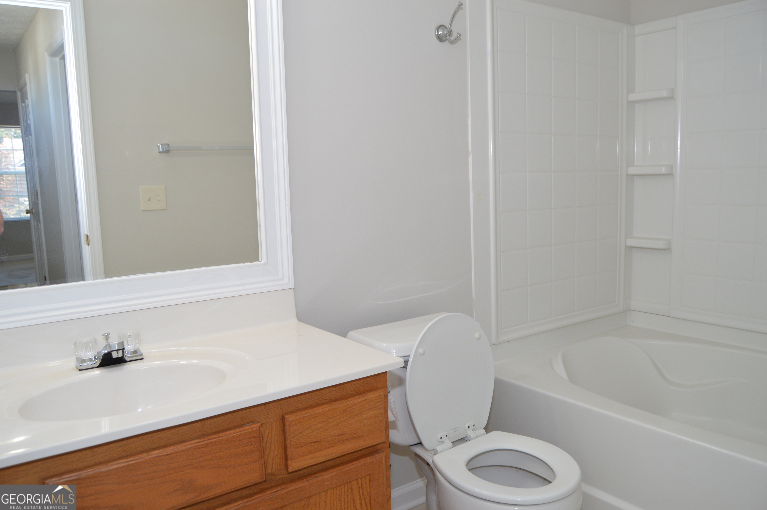 5765 Ridge Stone Way Cumming, GA 30041 - Photo 14 of 22 a bathroom with a sink a toilet and bathtub
