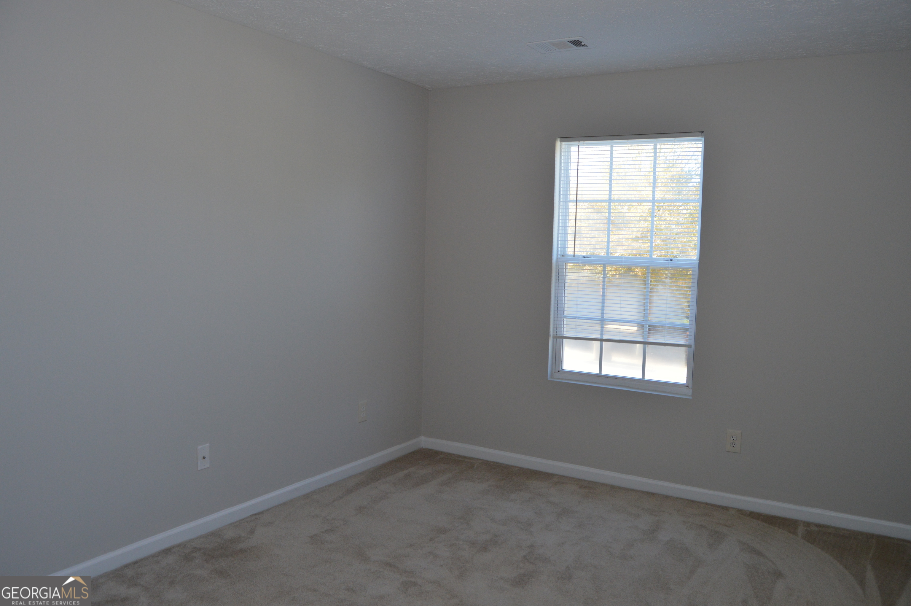 5765 Ridge Stone Way Cumming, GA 30041 - Photo 15 of 22 an empty room with a window