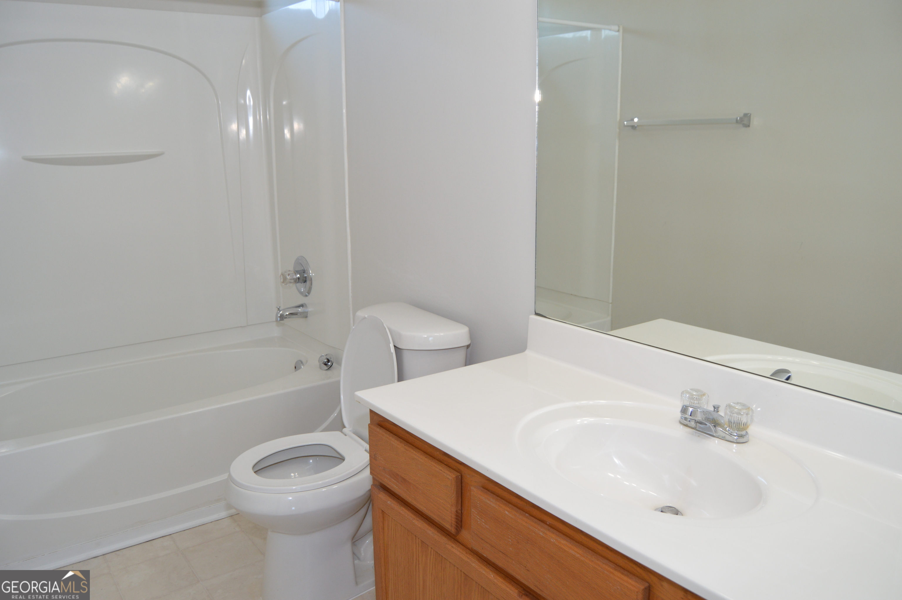 5765 Ridge Stone Way Cumming, GA 30041 - Photo 18 of 22 a bathroom with a sink a toilet and bathtub
