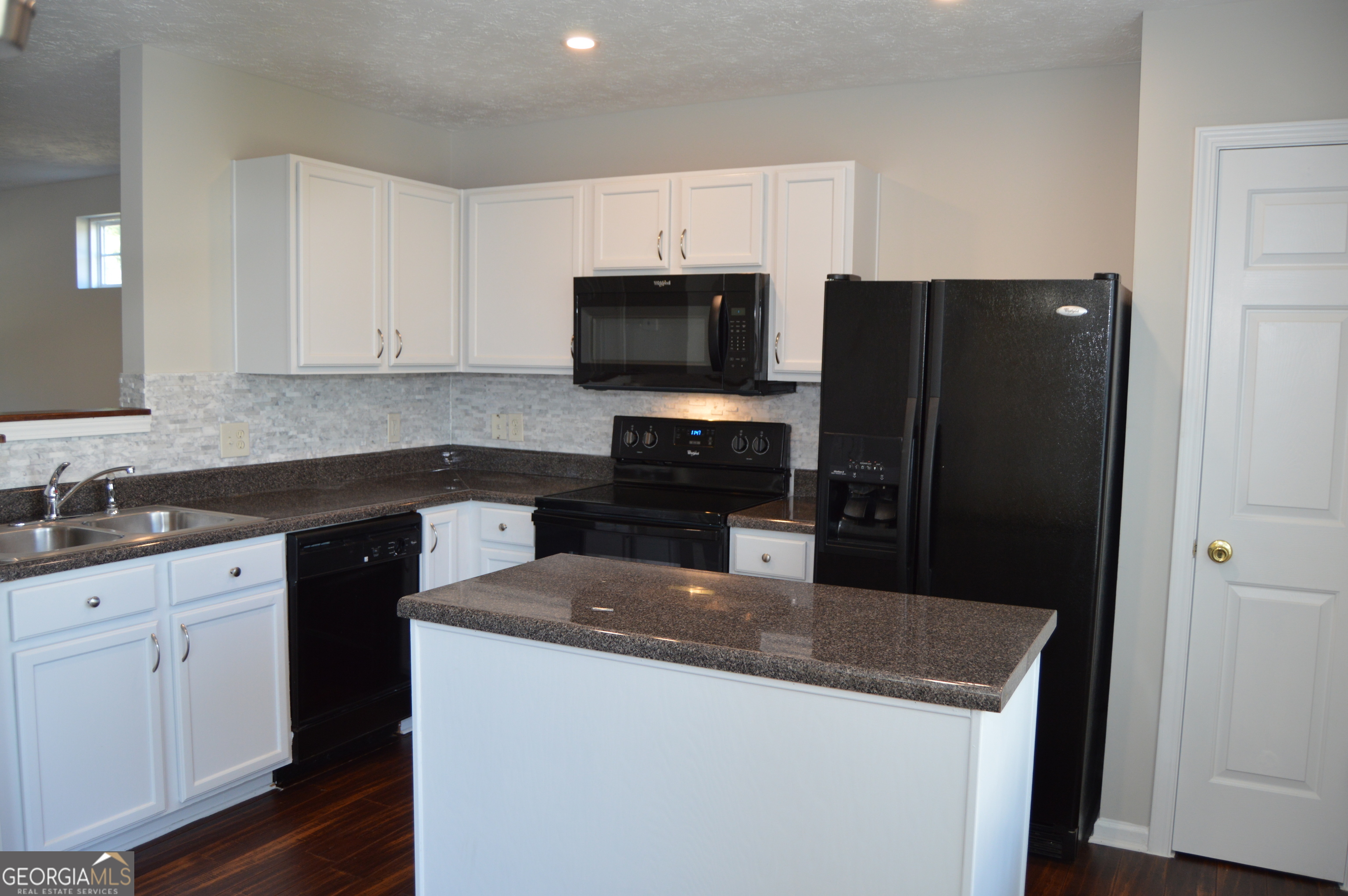 5765 Ridge Stone Way Cumming, GA 30041 - Photo 5 of 22 a kitchen with a sink a stove and refrigerator
