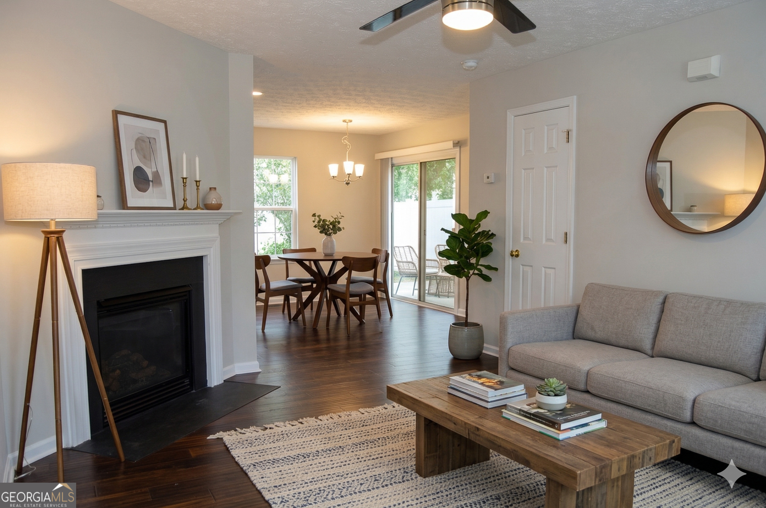 5765 Ridge Stone Way Cumming, GA 30041 - Photo 6 of 22 a living room with furniture a fireplace and a chandelier