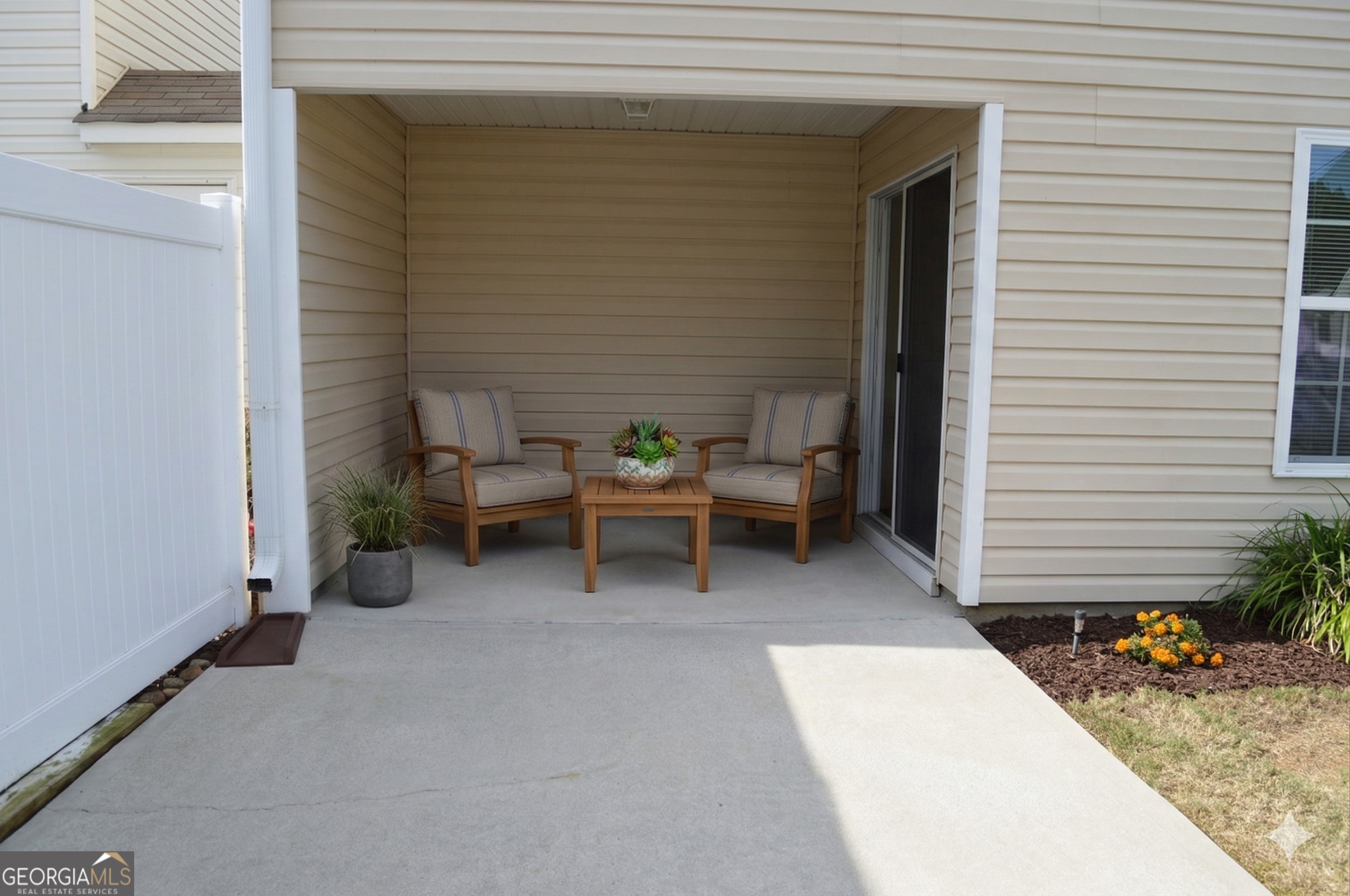 5765 Ridge Stone Way Cumming, GA 30041 - Photo 7 of 22 a view of a patio with table and chairs and potted plants