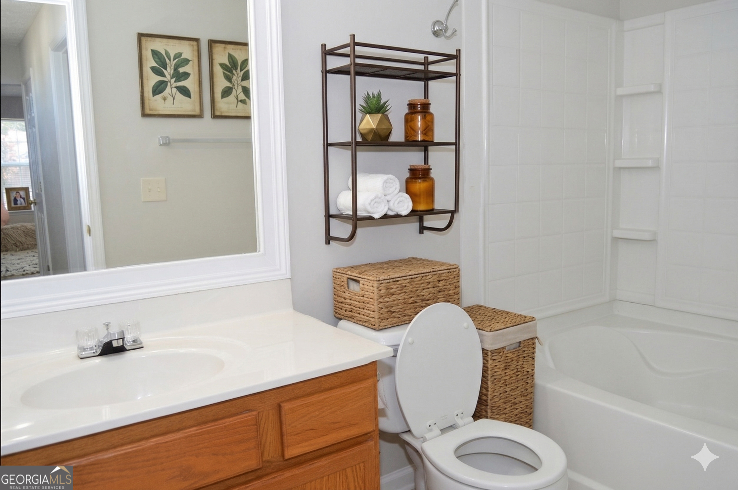 5765 Ridge Stone Way Cumming, GA 30041 - Photo 10 of 22 a bathroom with a granite countertop toilet sink and mirror