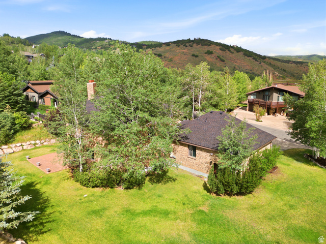 3535 Homestead Road Park City, UT 84098 - Photo 72 of 81 Expansive green lawn surrounding a brick residence with a dark shingle roof