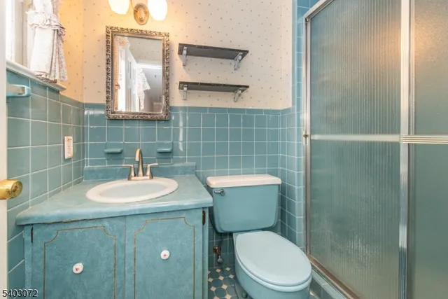 a bathroom with a toilet a sink and mirror