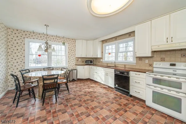 a kitchen with a stove a sink and cabinets