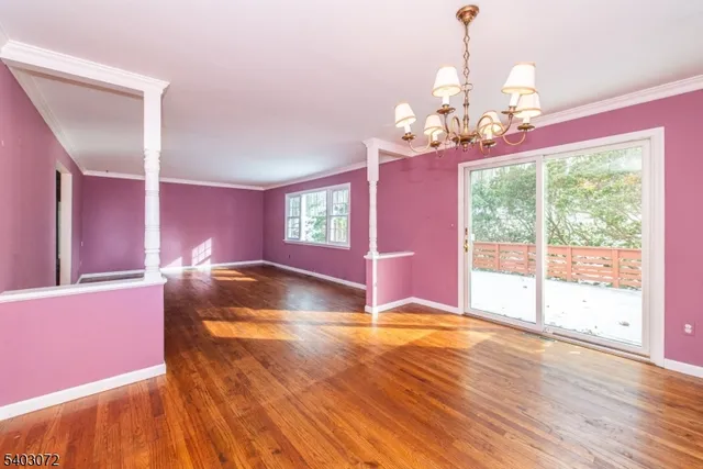 a view of a livingroom with a chandelier couches and chandelier