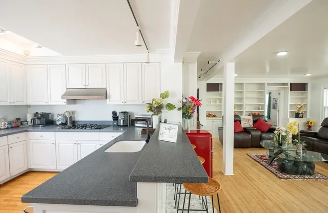 a kitchen with sink and cabinets